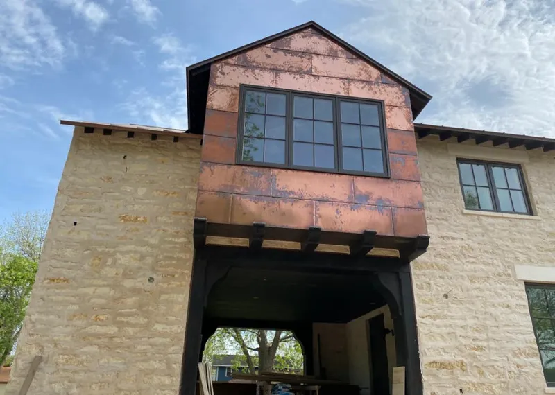 Copper metal panel facade on a stone building for Metal Roof Coating in Fairhope