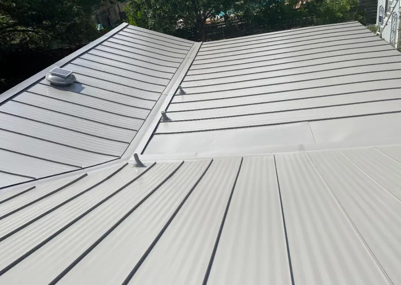 Solar attic fan installed on a metal roof for Roof Ventilation in Fairhope